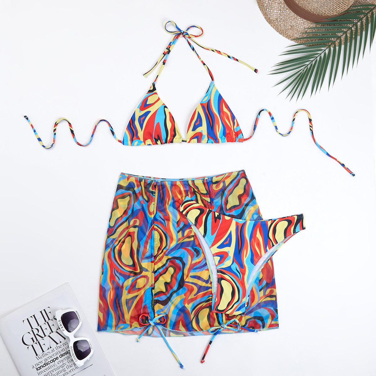 Modernes Damen-Bikini-Set mit Dreieck-Oberteilen, halbtransparentem Wickelrock und buntem Berg-Feld-Muster